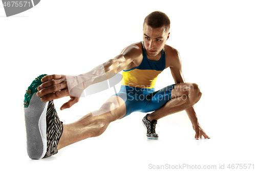 Image of Young caucasian man running or jogging isolated on white studio background.