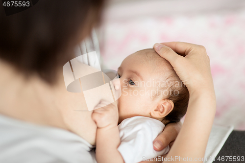 Image of close up of mother breastfeeding newborn baby