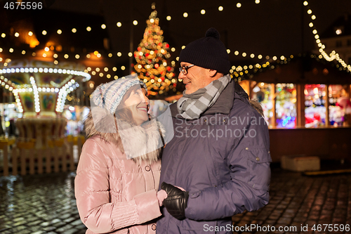 Image of happy senior couple at christmas market