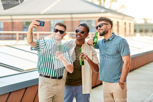 Image of men drinking beer and taking selfie by smartphone