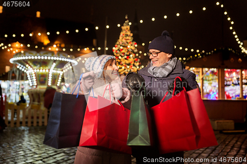 Image of old couple at christmas market with shopping bags