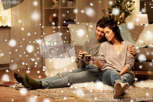 Image of happy couple drinking coffee and eating at home