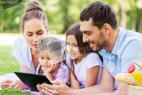 Image of family with tablet pc on picnic in summer park