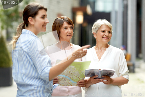 Image of passerby showing direction to senior women in city