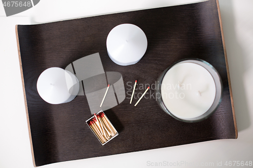 Image of fragrance candles and matches on tray on table