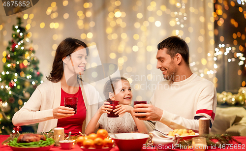 Image of happy family having christmas dinner at home