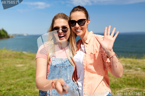 Image of teenage girls or friends taking selfie in summer