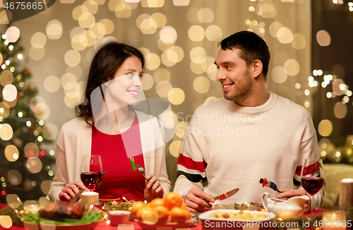 Image of happy couple eating at christmas dinner