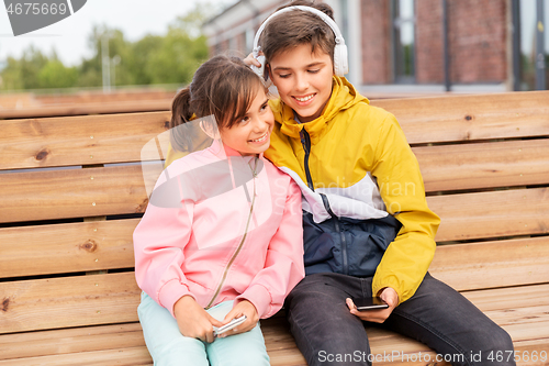 Image of bou and girl with headphones listening to music