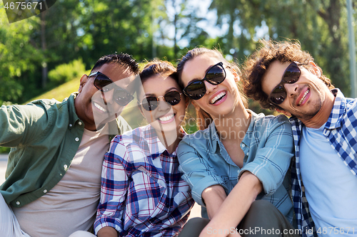 Image of happy friends taking selfie at summer park