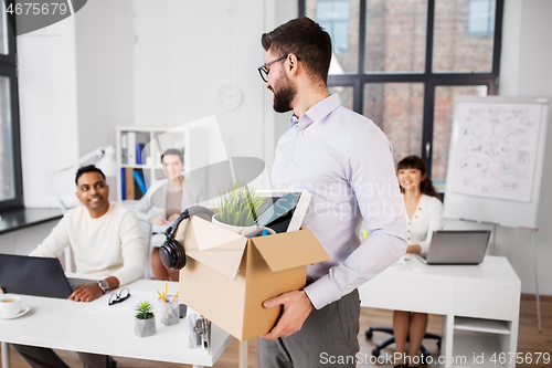 Image of happy male office worker with personal stuff