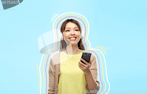 Image of asian woman in headphones listening to music