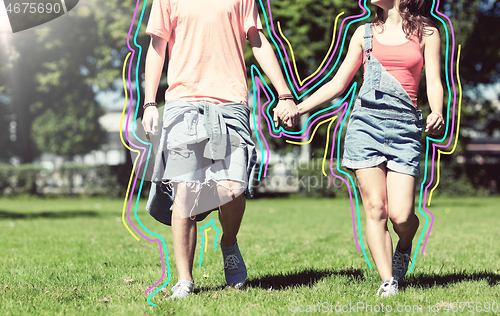 Image of happy teenage couple walking at summer park