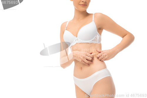 Image of Beautiful female belly and chest isolated on white background. Beauty, cosmetics, spa, depilation, treatment and fitness concept, sensual posing