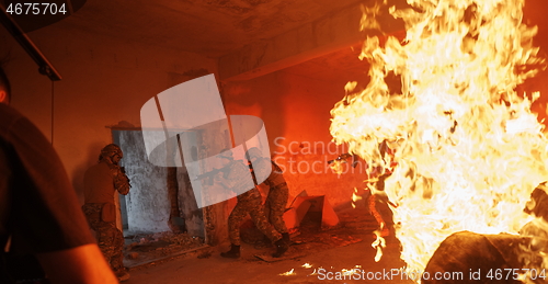 Image of Videographer Taking Action Shoot of Soldiers in Action urban environment