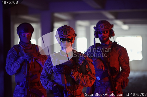 Image of soldier squad team portrait in urban environment colored lightis