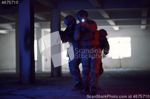 Image of Soldiers squad in tactical formation having action urban environment