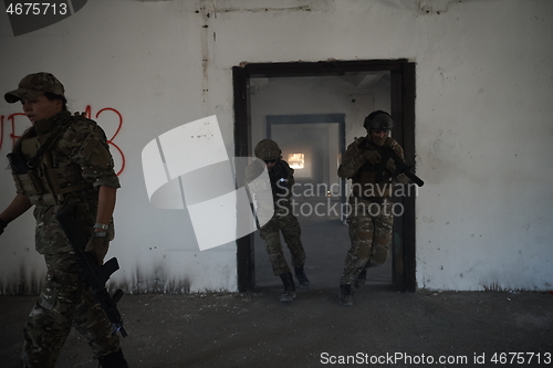 Image of military troops in action urban environment