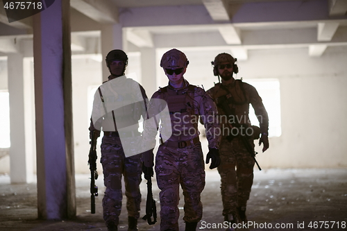 Image of soldier squad team portrait in urban environment colored lightis