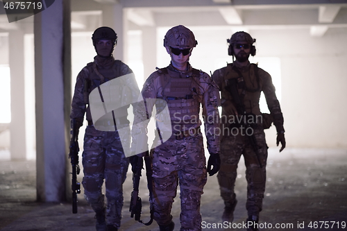 Image of soldier squad team portrait in urban environment colored lightis