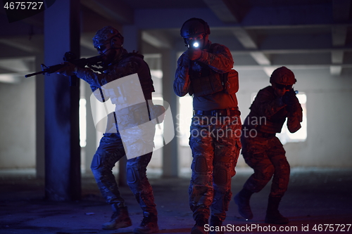 Image of Soldiers squad in tactical formation having action urban environment