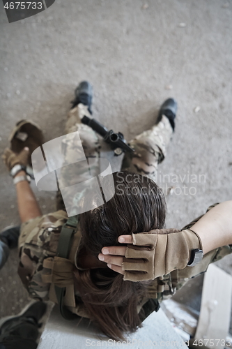 Image of military female soldier having a break