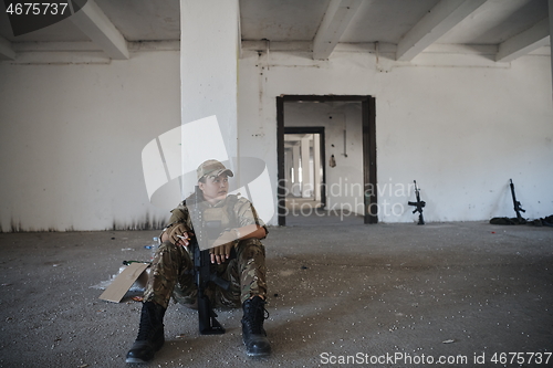 Image of military female soldier having a break