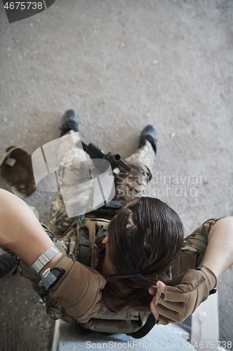 Image of military female soldier having a break