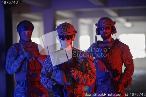 Image of soldier squad team portrait in urban environment colored lightis