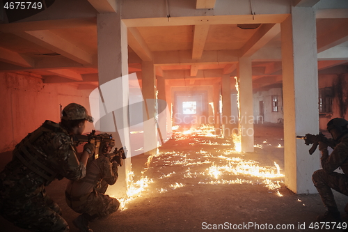 Image of military troops in action urban environment