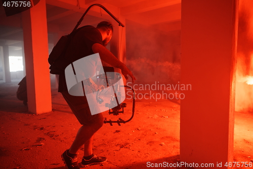 Image of Videographer Taking Action Shoot of Soldiers in Action urban environment