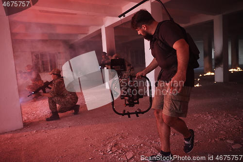 Image of Videographer Taking Action Shoot of Soldiers in Action urban environment