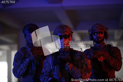 Image of soldier squad team portrait in urban environment colored lightis