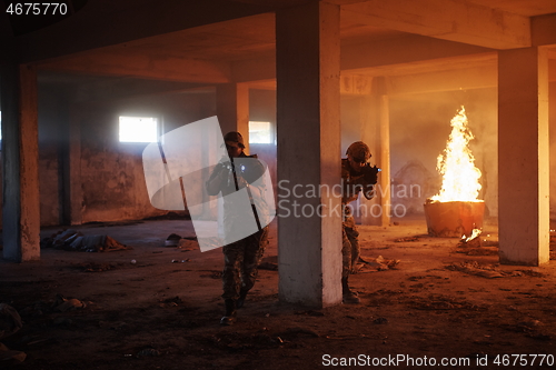 Image of military troops in action urban environment