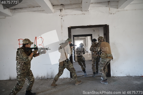 Image of military troops in action urban environment