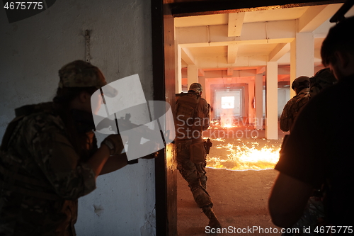 Image of military troops in action urban environment