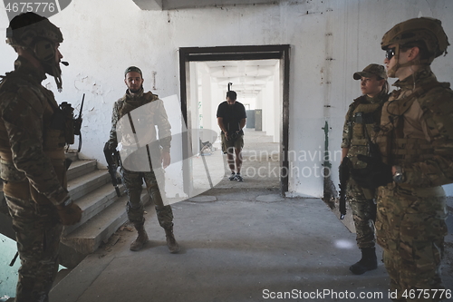 Image of Videographer Taking Action Shoot of Soldiers in Action urban environment