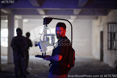Image of Videographer Taking Action Shoot of Soldiers in Action urban environment