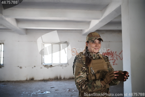 Image of military female soldier having a break