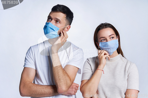 Image of Young couple wearing medicine masks