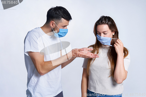 Image of Young couple wearing medicine masks