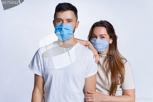 Image of Young couple wearing medicine masks