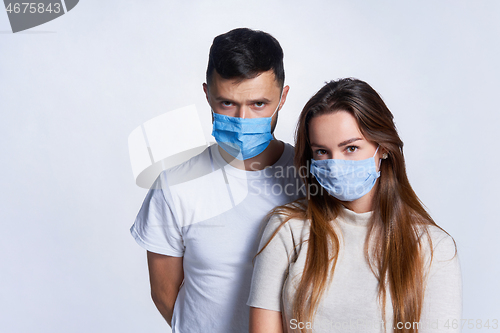 Image of Young couple wearing medicine masks