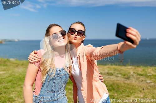 Image of teenage girls or friends taking selfie in summer