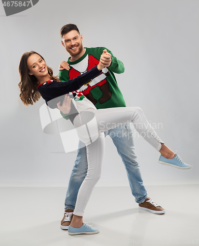 Image of couple dancing at christmas ugly sweater party