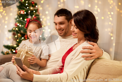 Image of family with smartphone at home on christmas