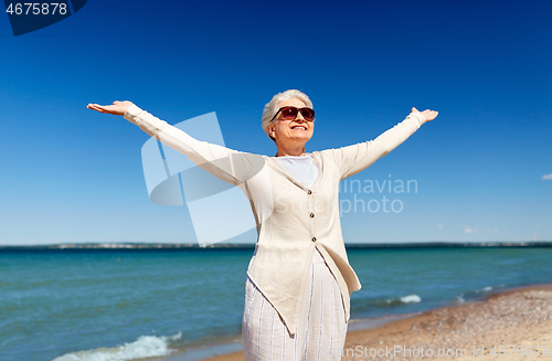 Image of portrait of senior woman in sunglasses on beach