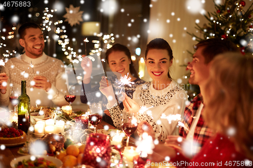 Image of happy friends celebrating christmas at home feast