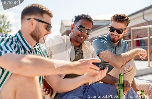 Image of men with smartphone drinking beer on street