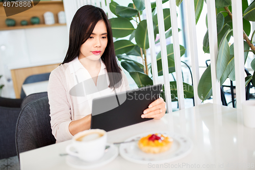 Image of asian woman with tablet pc at cafe or coffee shop